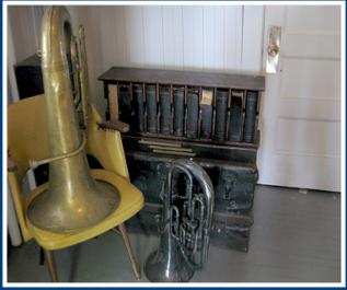 BOOK CASE AND INSTRUMENTS IN THE HISTORY ROOM